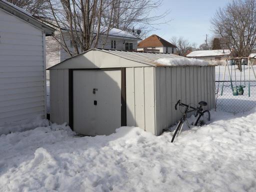 Shed behind garage stays with the home and is great for additional storage