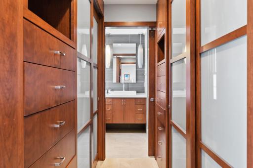 The quality and craftsmanship of the custom closet organization system as well as the owner's private bathroom is best experienced in person.