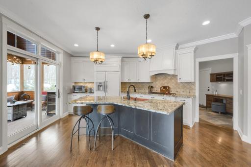 Gourmet chef's kitchen featuring 6-burner Wolf gas range, copper sink, granite counters, and more