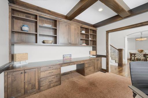 Built-in desk and wood beamed ceiling in the office