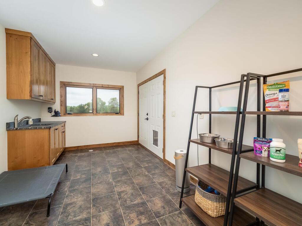 Storage room (Dog room) with our dog door leading out to the dog yard.