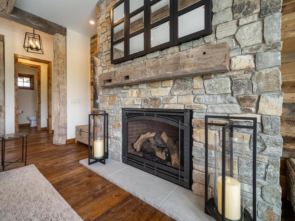 Floor to ceiling stone front fireplace.