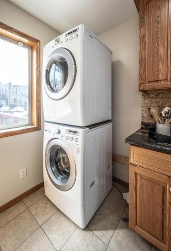 Bonus! Laundry is at the back of the kitchen! Full-sized front loading stackable washer and dryer.