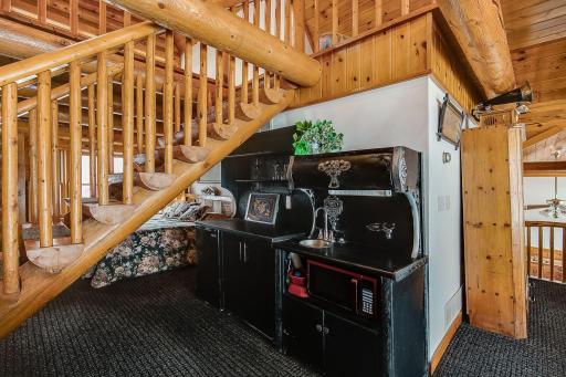 Family room has water and a refrigerator