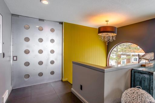 Custom-built ventilated sliding door leading into the Master Suite that allows for the lake breeze to pass through even when closed.