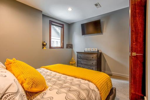 Main-floor Guest Room with south-facing window with lake views, plus a spacious walk-in closet.