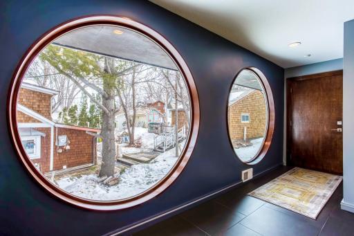 Two 6' circular custom Anderson windows leading down the hallway to the Garage and Laundry Room.