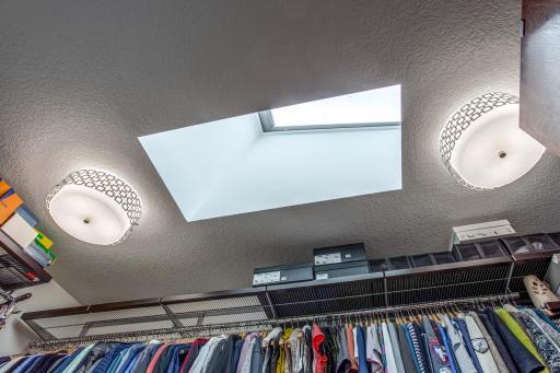 Custom walk-in closet with skylight that features a remote that can open/close it, a rain sensor, shades, and more!