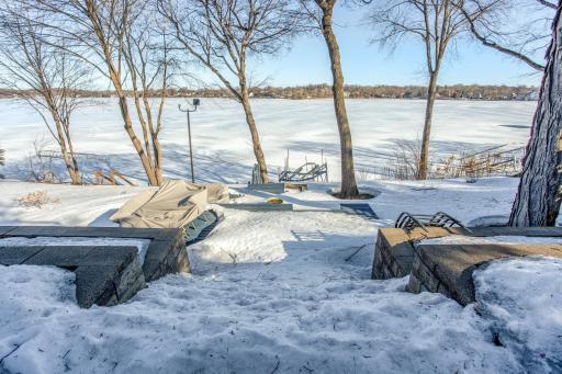 700 Sq Ft of outdoor living space (Cedar decking painted in Fall 2022), professionally designed and lush multi-tiered landscaping, and 2’ x 4’ Bluestone tile walkway/stairs leading to the lake.