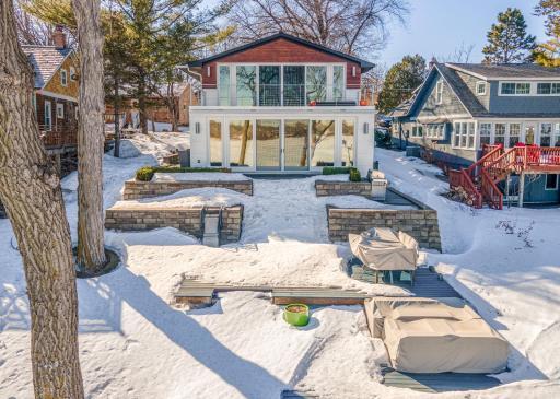 Enjoy over 700 sq ft of outdoor living space or enjoy a late-night bonfire, 10’ from the lakeshore in the separate firepit area.