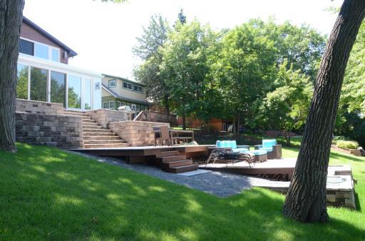 700 Sq Ft of outdoor living space (Cedar decking painted in Fall 2022), professionally designed and lush multi-tiered landscaping, and 2’ x 4’ Bluestone tile walkway/stairs leading to the lake.