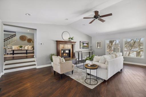 Vaulted ceilings and a wood-burning fireplace give this main level family room a spacious-yet-cozy feeling.
