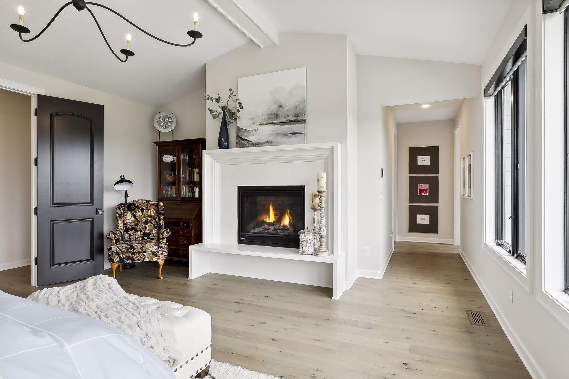 Primary Suite with hardwood floors and vaulted ceiling
