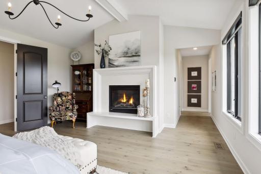 Primary Suite with hardwood floors and vaulted ceiling