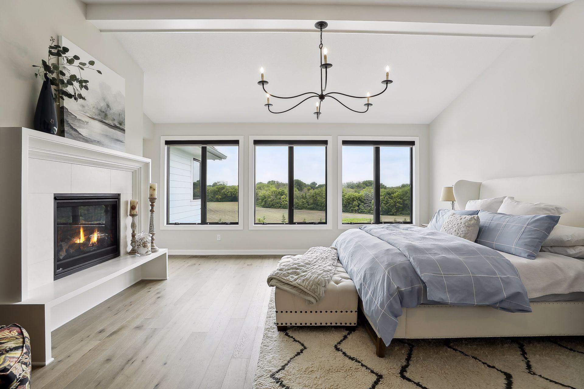 Primary suite with gas fireplace and views of the yard and pool