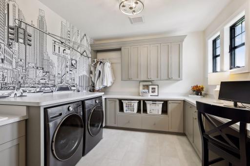 Upper level laundry with drying rack and cabinets