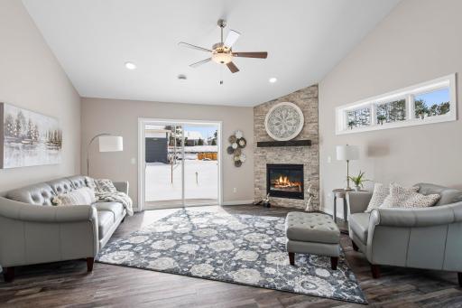 Floor to ceiling Natural Ledgestone gas fireplace is included.
