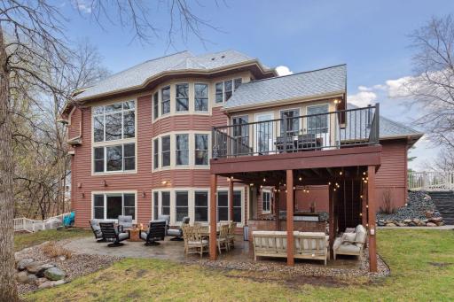 Outdoor Seating around Gas Firepit on Large Paver Patio next to Outdoor Kitchen