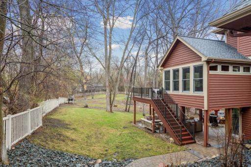 4 Season porch/Deck overlooking Completely Fenced in Backyard with extensive Rock Landscaping