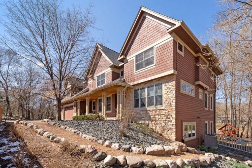 Yellow stone path on the side of the home leading to backyard