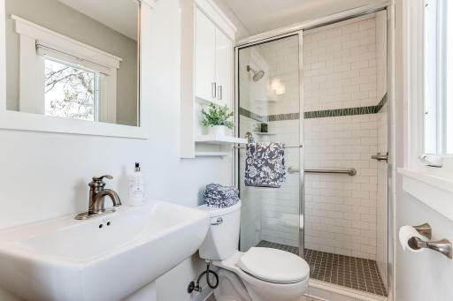 Photo for 3424 Utah Avenue N, Crystal, MN 55427 - Listing #6354239 Totally updated Primary bath with pedestal sink, custom toiletry cabinet, tile floor, and tile shower surround.