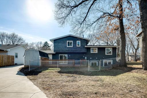 Photo for 3424 Utah Avenue N, Crystal, MN 55427 - Listing #6354239 Back of the home. Private gate access to In-Law unit patio and atrium door. Chain link fencing is enclosed to back of the home.