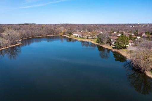The aerial view of your new home along the shores of Boundary Creek Pond. This peaceful oasis welcomes you. Just add a kayak, hammock, bike, and bonfire. Welcome home to 9986 106th Place North.