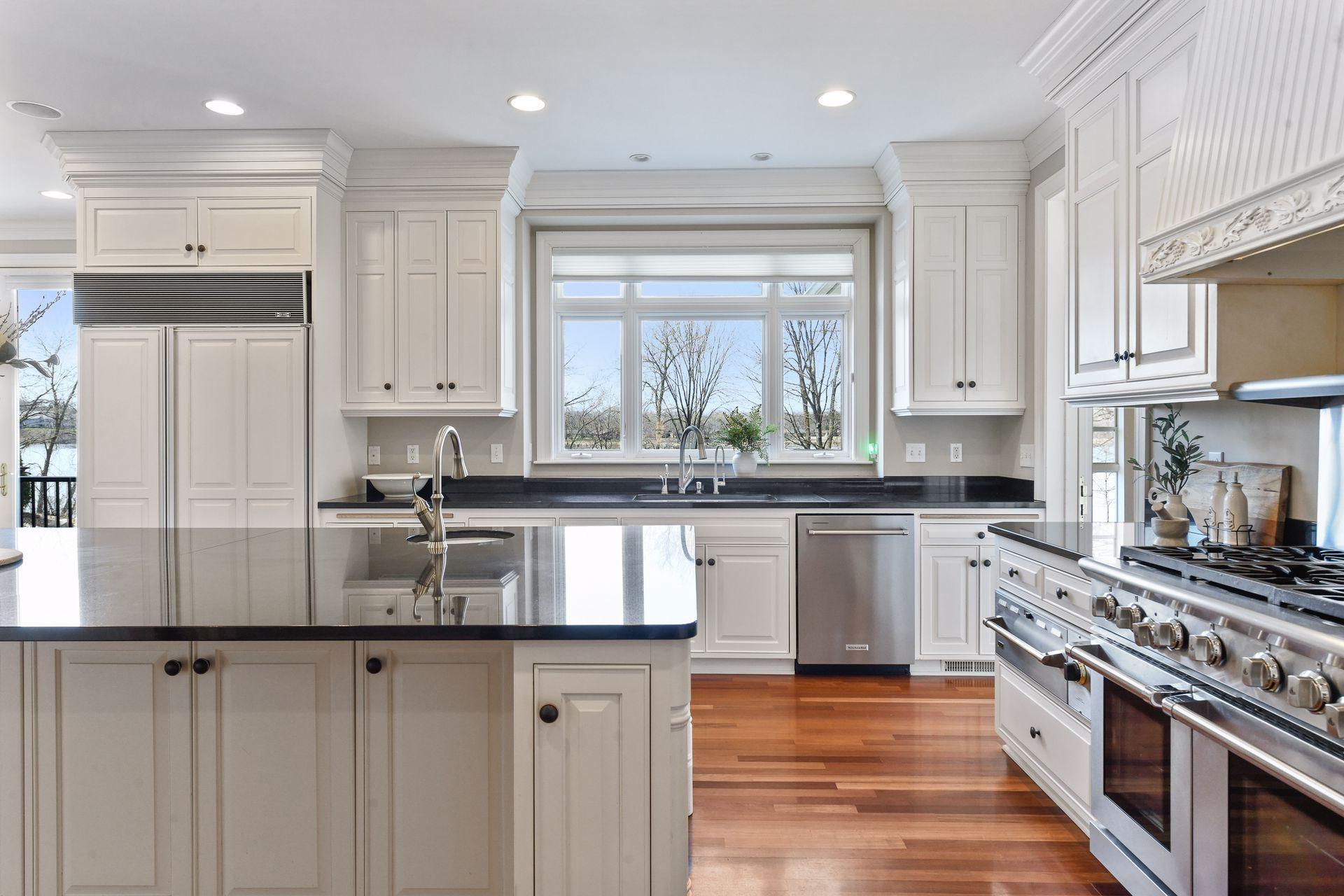 The kitchen offers a pretty view to the expansive backyard and Gleason Lake