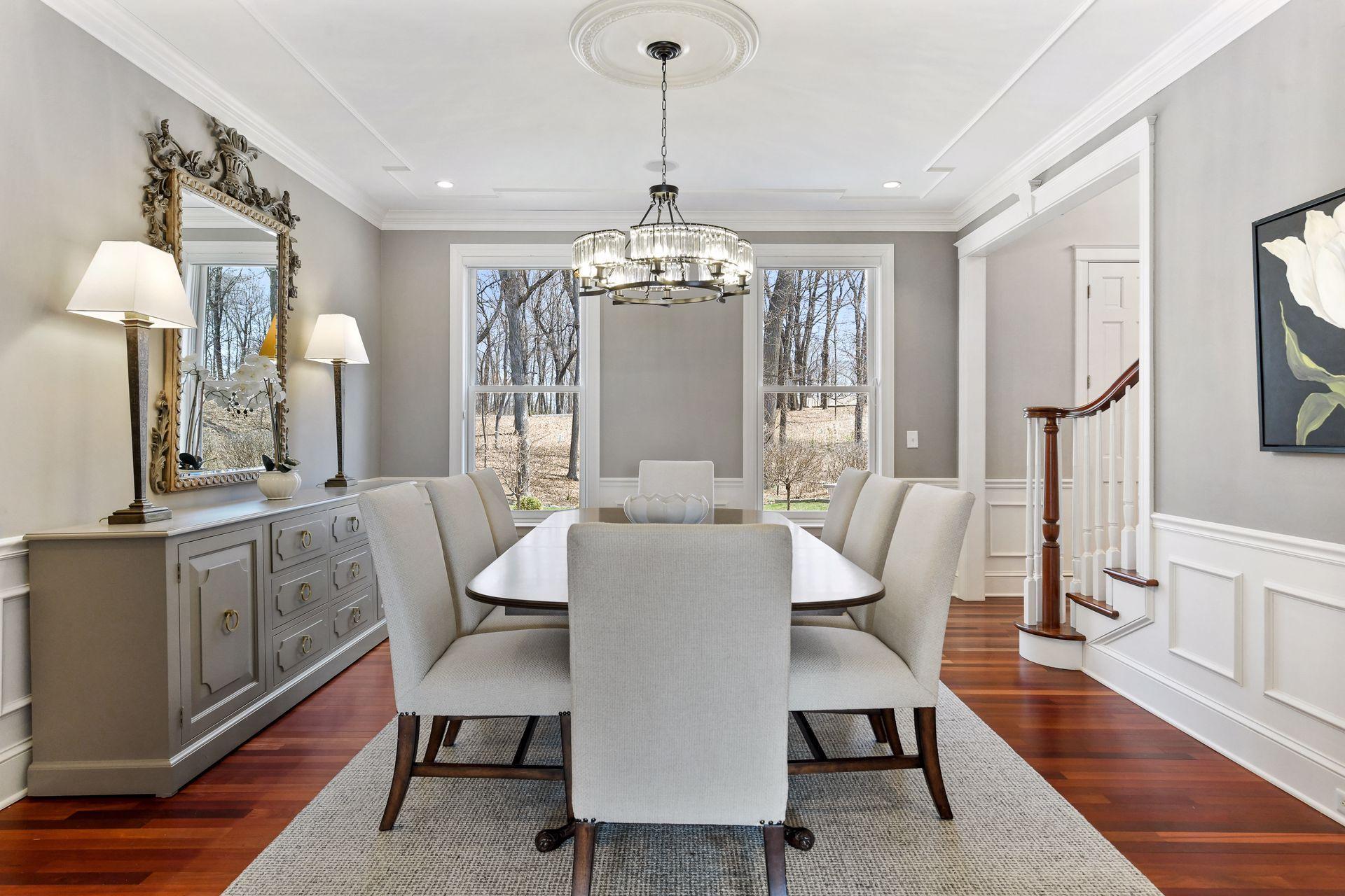 An elegant formal dining area with views of the wooded front yard makes the ideal space to entertain