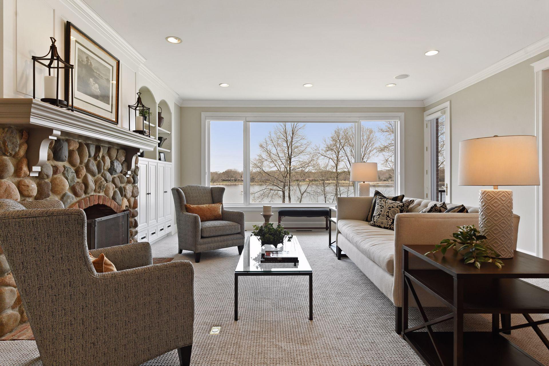 A spacious great room with expansive windows is filled with natural light