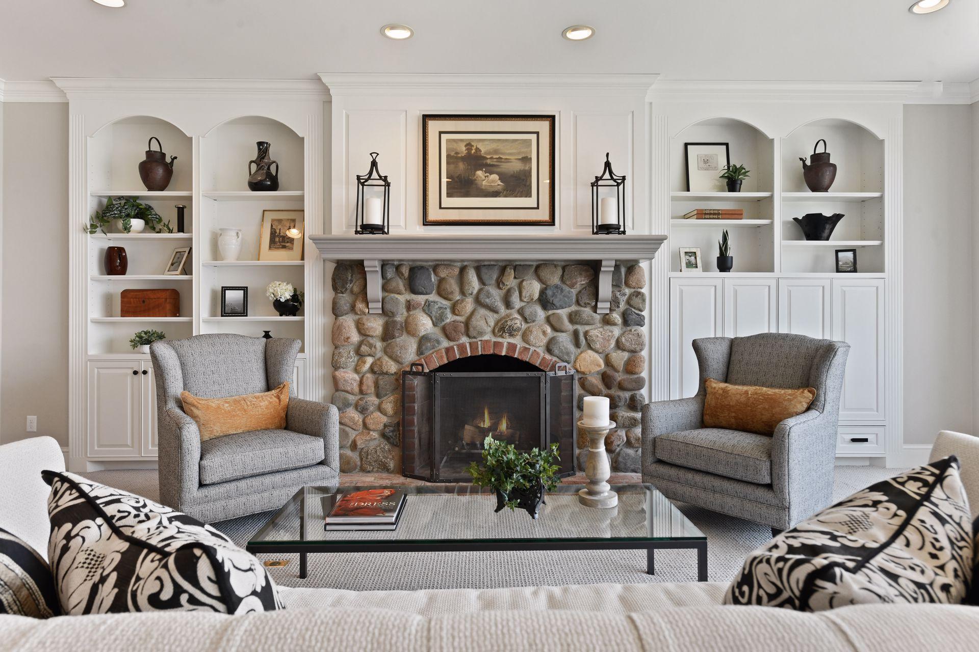 The inviting river rock fireplace is flanked by built-in shelving that's perfect for displaying your collectable decor