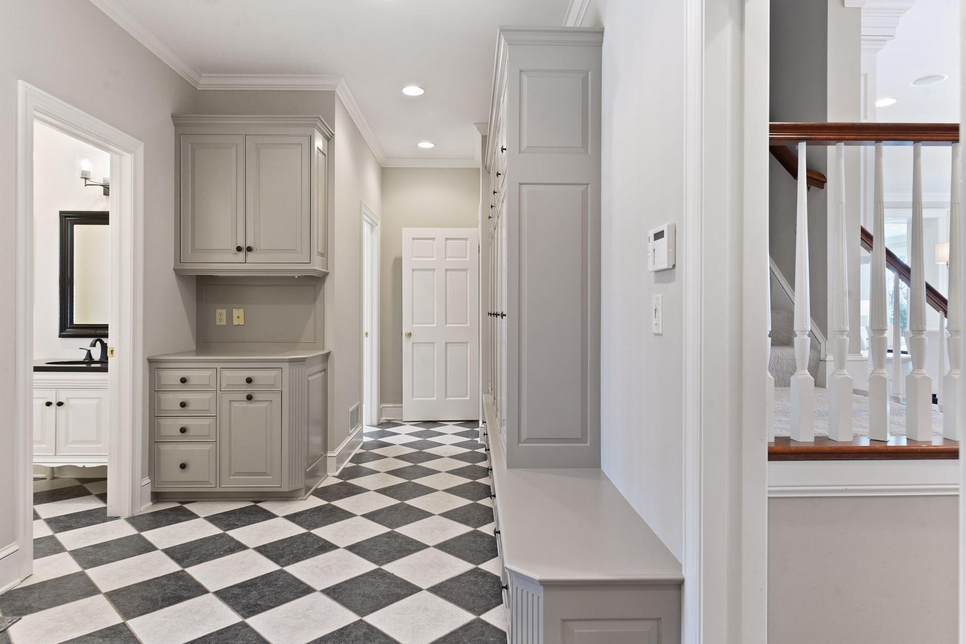 Back entry with bench seating, individual cubbies to keep outerwear organized, additional closet space, and a handy drop zone