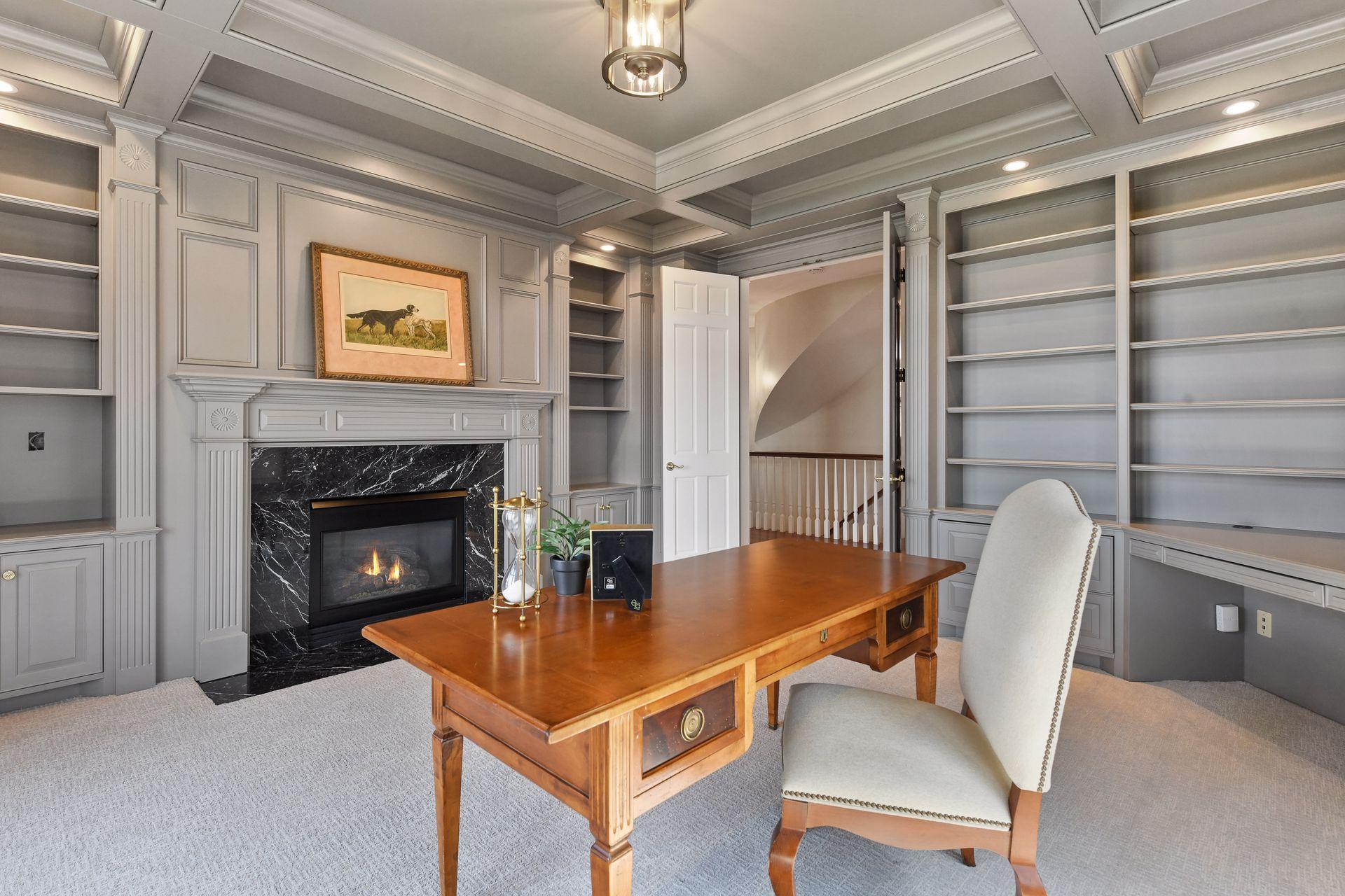 Gas fireplace, beautiful built-in cabinetry, box beamed ceiling details lend an air of sophistication to this room
