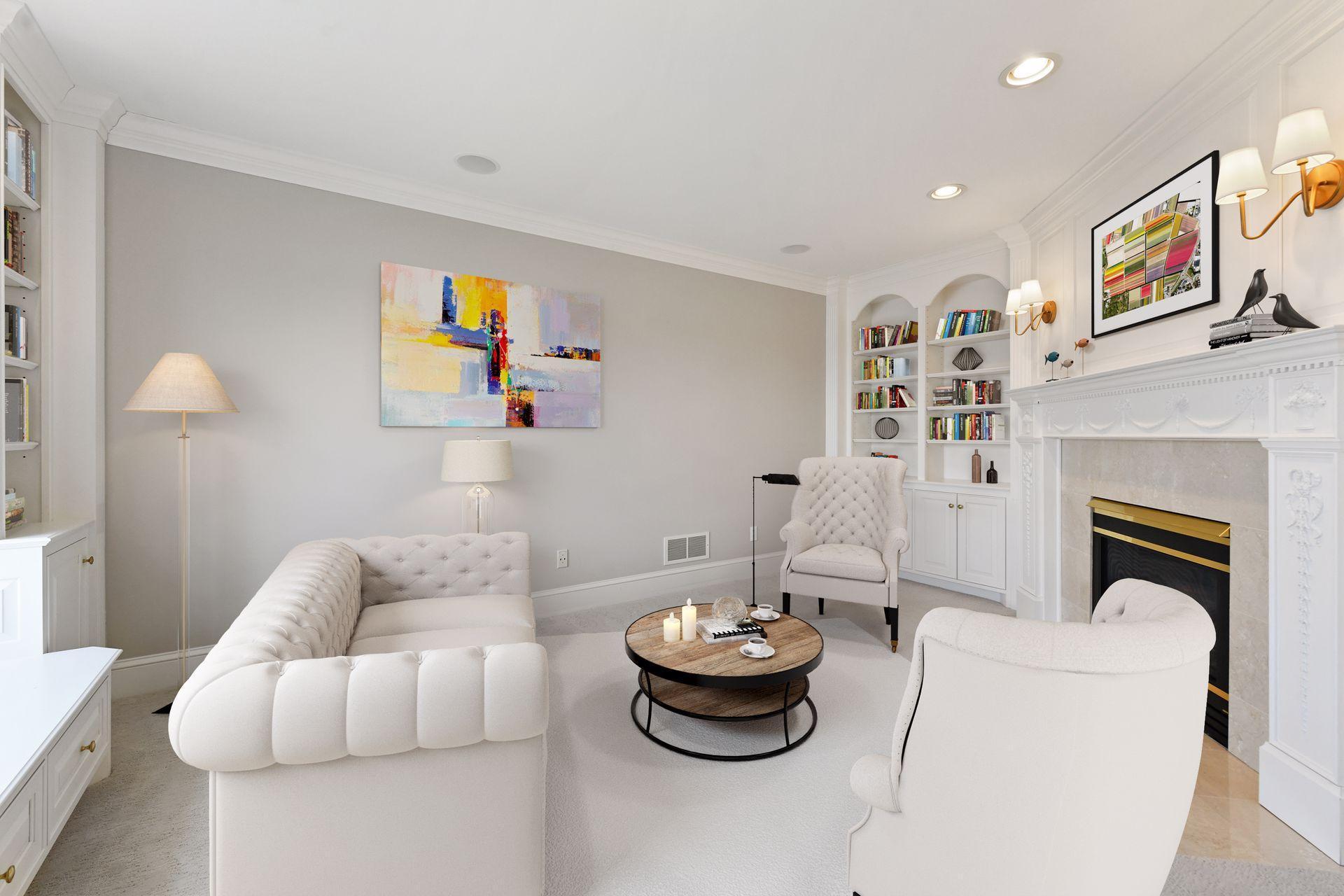 The private sitting room located off the owner's bedroom features a gas fireplace, built-ins, and views overlooking the back yard and lake beyond