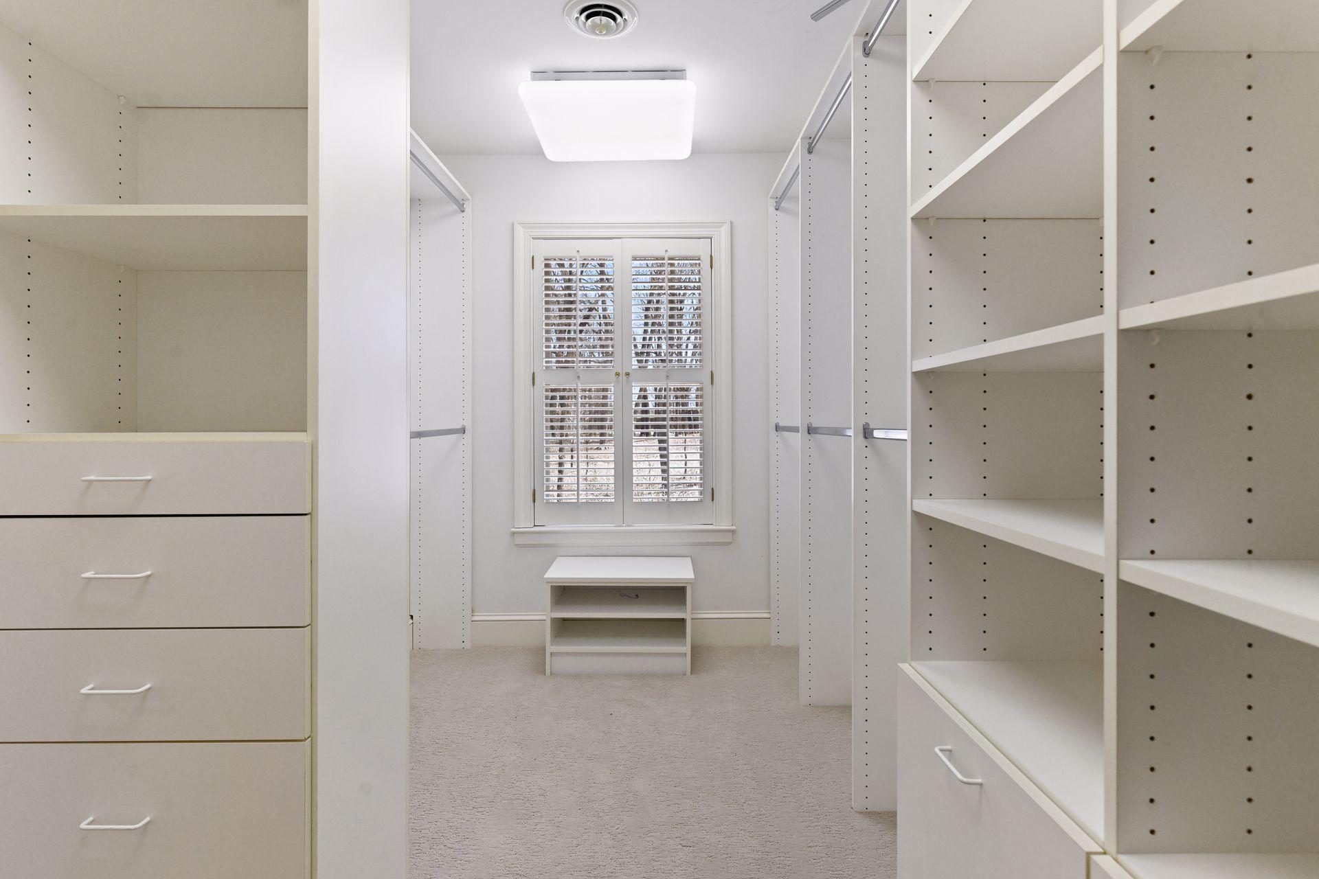 One of two large walk-in closets with organizational components located in the owner's suite