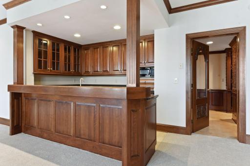 Beautiful warm wood creates an inviting spot to gather at the bar