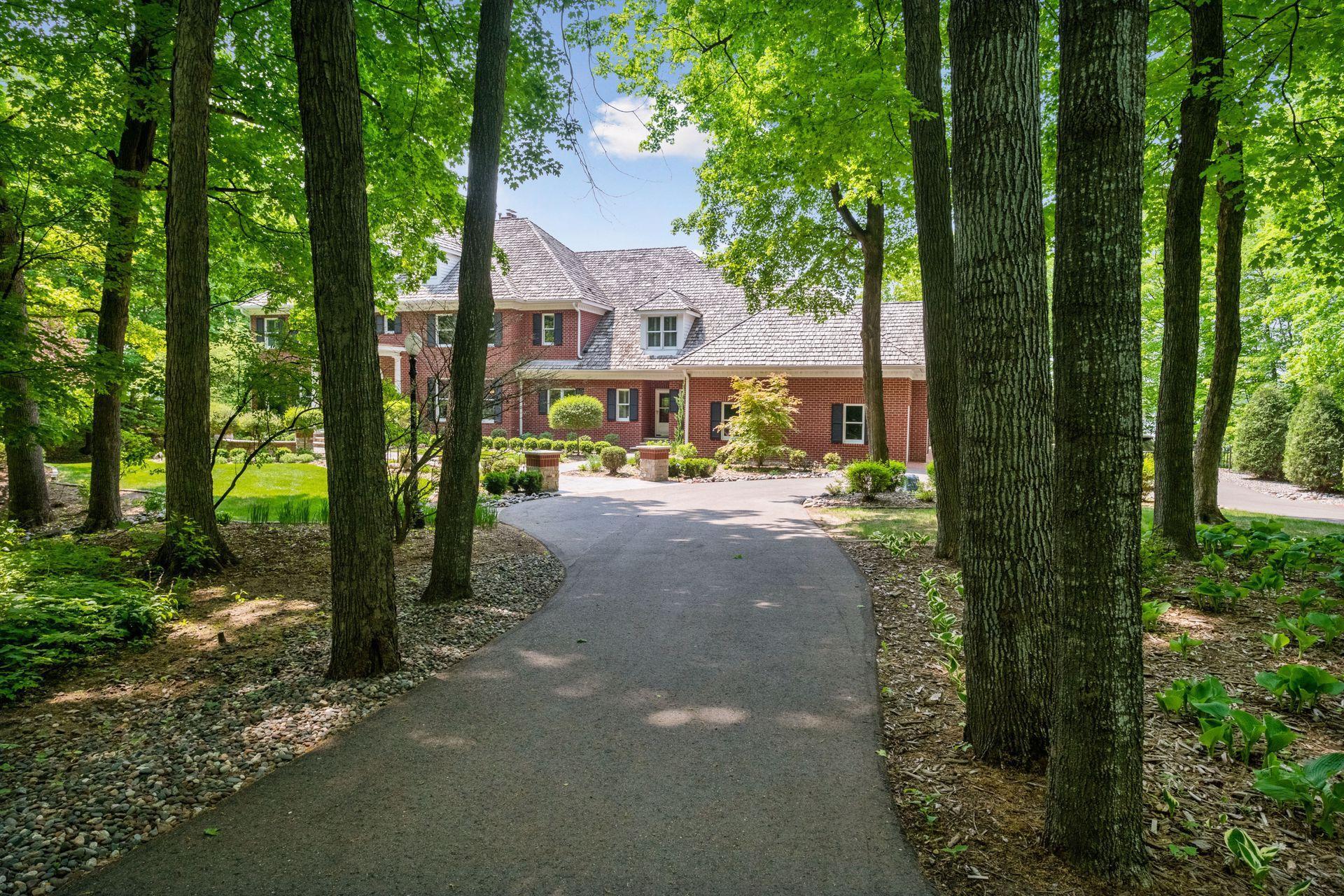 A tranquil approach to this 2-acre estate just a short drive from downtown Wayzata