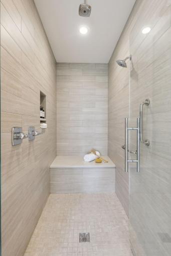 The primary bathroom has a dual head walk-in tiled shower.