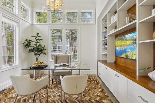 The study has built-in wood and enameled cabinets, bookcases and a place for your TV. Looking up, youâll notice a unique pyramid ceiling, beautiful chandelier, and endless surrounding windows with a view of the bluffs off the south side.