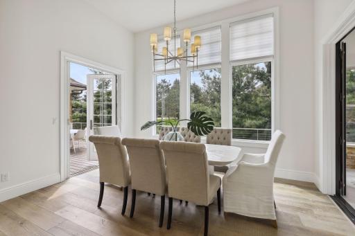 French doors lead to the deck on one side and to the four-season porch on the other. Another beautiful chandelier casts over your table as you entertain or host dinner parties, comfortable to seat 8+ guests.