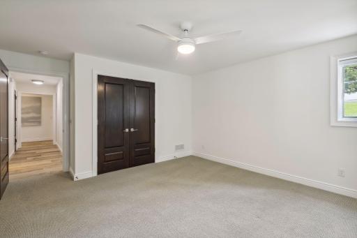 At the end of the hallway is another generous sized bedrooms with French door closets and large windows.