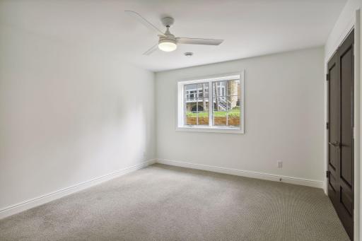 A second spacious bedroom is filled with natural light.