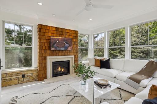 The porch features a limestone floor, gas burning fireplace with shake accent wall and cast stone surround, a place for your TV, and in-floor heat.