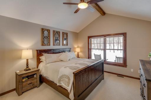 Main floor primary bedroom features hand-hewn beam!