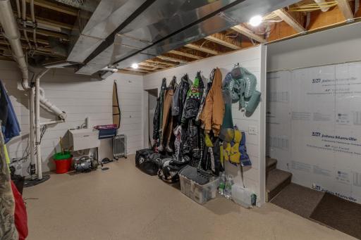 Lower level storage with stairs leading outside.