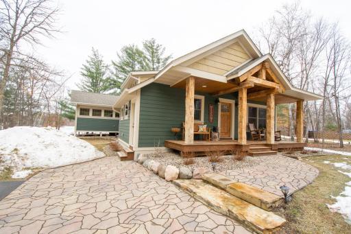 Love this front porch with hand hewn beams!
