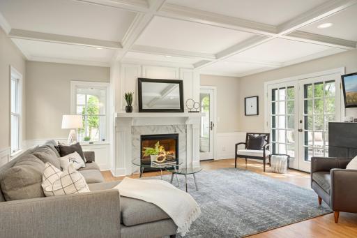 Main floor family room with offered ceilings connects to the private backyard and screened porch.