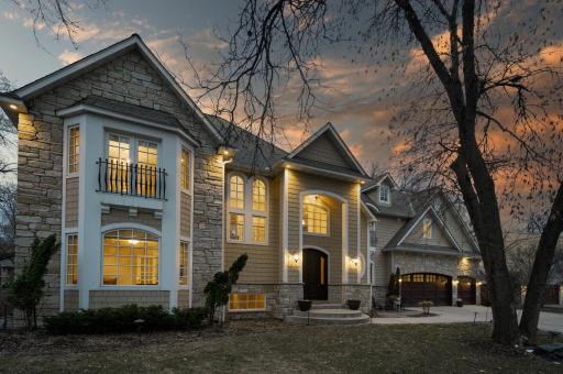 Incredible custom two-story home situated on a spacious .51-acre lot with beautiful Minnehaha Creek flowing beyond the backyard!