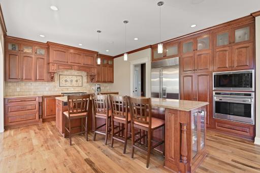Enormous center island with seating and pendant lighting above.