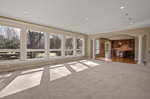 A full wall of floor to ceiling windows provide another amazing view of the backyard and Minnehaha Creek!